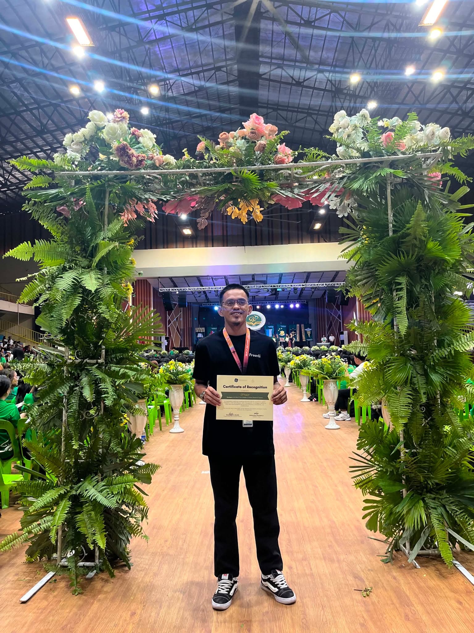 A Proovli team member holding the certificate of recognition during the awards event.